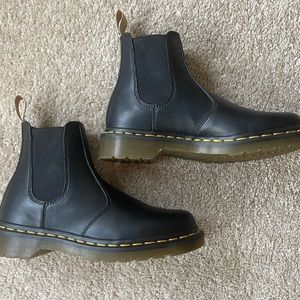 Dr. Martens black Chelsea boots.